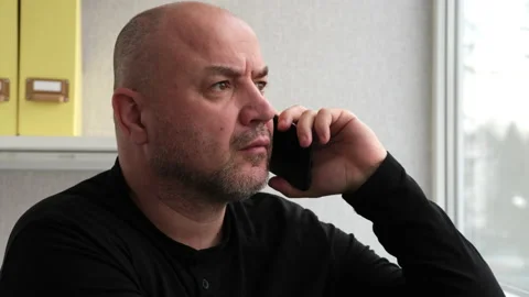 Closeup serious man talking mobile phone in office. Businessman having call Video stock 237798366