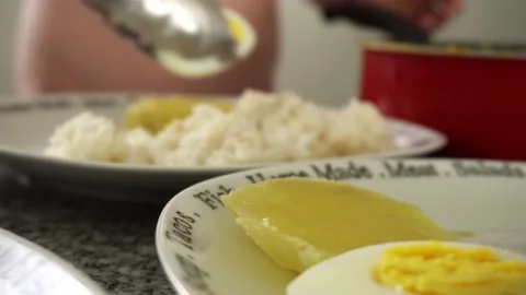Closeup serving aji de pollo on plates with rice and boiled eggs with potatoes Stock Footage 189104875