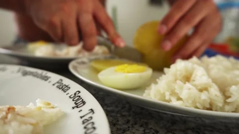 Closeup serving the food in several plates and defocused cutting potatoes with a Stock Footage 189103355
