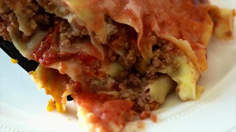 Closeup of serving homemade lasagna on a plate Stock Footage 250201215