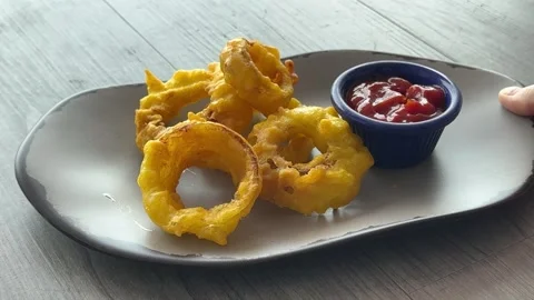 Closeup of Serving a Plate of Deep Fried Onion Rings Stock Footage 316908940