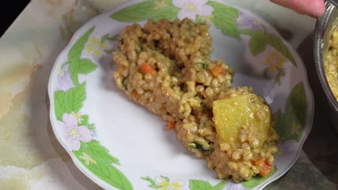 Closeup serving wheat stew with potatoes on a white plate Stock Footage 141024292