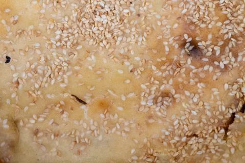 Closeup of sesame bread highlighting irregular baking marks. Urban snack pr.. Stock Photos