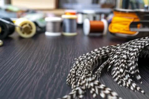 Closeup set of different accessories for knitting flies for fly fishing. Фото