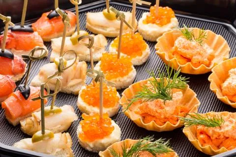 Closeup set different canapes and snacks Stock Photos