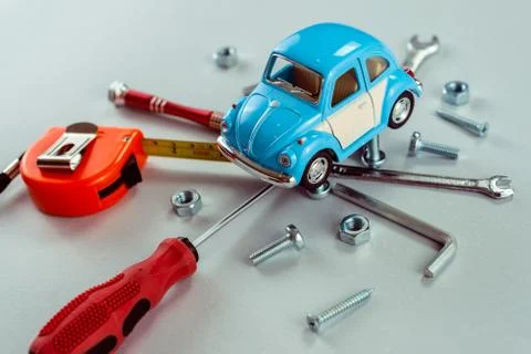 Closeup set of tools wrenches with blue toy car. Car repair concept.  - Image Stock Photos