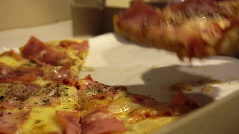 Closeup of several hands taking several slices of pizza out of a cardboard box Stock Footage 181770889