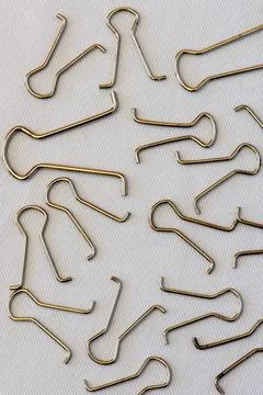 Closeup of several paper clips in different positions and arranged randomly. Stock Photos