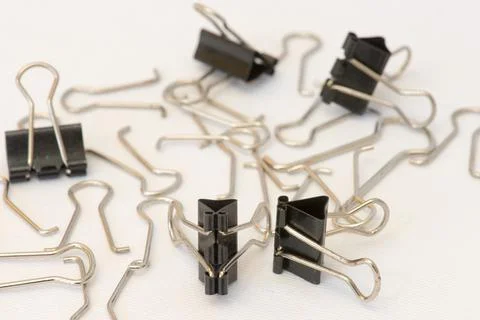 Closeup of several paper clips in different positions and arranged randomly. Stock Photos