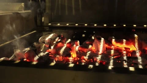 Closeup of several pieces of red hot charcoal from a grill at night 4k Stock Footage 173522097