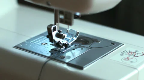 Closeup of sewing machine with the hands of a tailor Stock Footage 34600289
