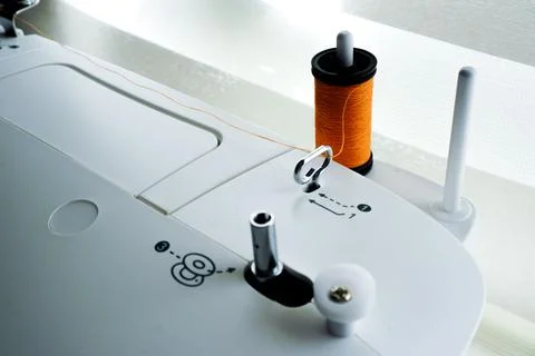 Closeup of a sewing machine needle bobbin and stitch settings Stockfoto's