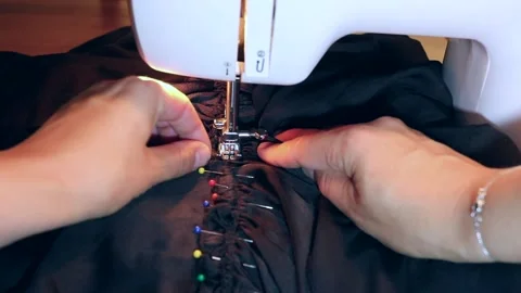 Closeup of sewing machine, satin fabric, pins and hands Stock Footage 196241530