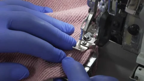Closeup of sewing process on the overlock in the atelier Video stock 157300277
