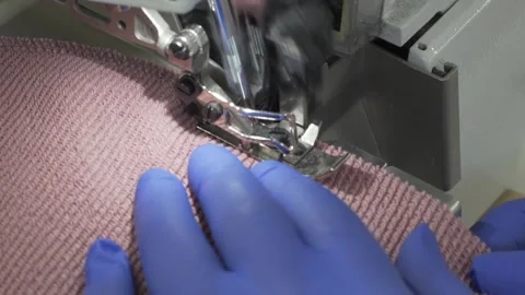 Closeup of sewing process on the overlock in the atelier Stock Footage 157300288