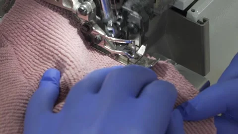 Closeup of sewing process on the overlock in the atelier Stock Footage 157812279