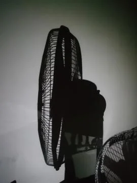 Closeup of shadow of a table fan white background Stock Photos