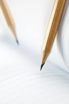 Closeup of sharp graphite pencil on white paper of notebook.  Concept of The Stock Photos