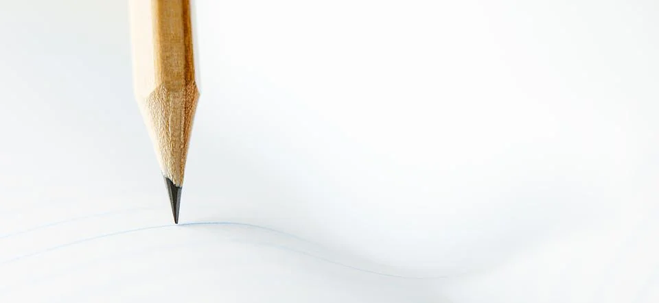 Closeup of sharp graphite pencil on white paper of notebook.  Concept of Th.. Stock Photos