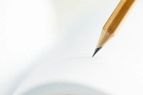 Closeup of sharp graphite pencil on white paper of notebook.  Concept of Th.. Stock Photos