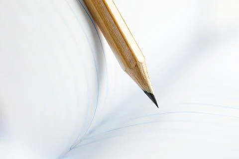 Closeup of sharp graphite pencil on white paper of notebook.  Concept of Th.. Stock Photos