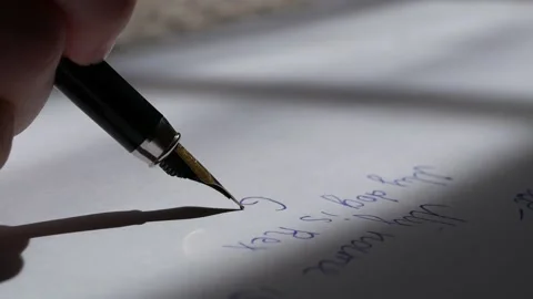 Closeup of a sharp pen on white paper wrote the text Vídeos de archivo 131677741