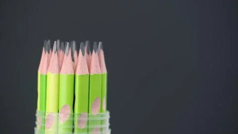 Closeup sharpened graphite pencils set rotates black background. office supplies Stock Footage 249190692