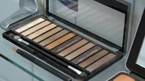 Closeup of a shimmer palette container as the brush takes the powder Stock Footage 127500053