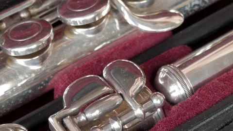 Closeup of shiny silver flute in a lined case, showing detailed keys and Stock Footage 341992242