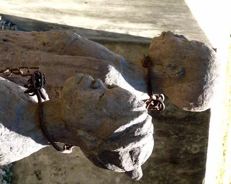Closeup shocking stone figures of slave monument, Stone Town, Zanzibar Stock Photos