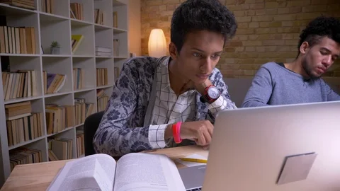 Closeup shoot by camera moving from indian to african american male students Stock Footage 108497437