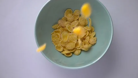 Closeup shoot of cornflakes being dropped in a bowl. Healthy and tasty all Video stock 112326390