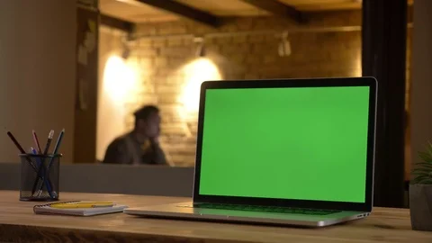Closeup shoot of a green chroma screen of the laptop lying on the desk in the Video stock 104143968