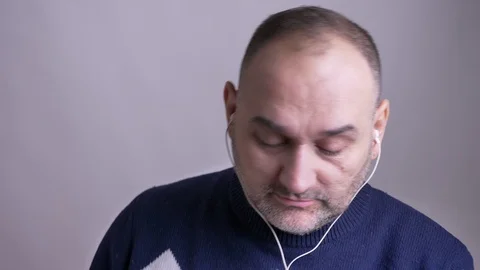 Closeup shoot of middle aged caucasian man listening to music in the vibes and Video stock 104501977