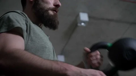 Closeup shoot of young athletic bearded caucasian man lifting dumbbells in the Stock-Footage 108759507
