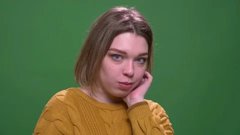 Closeup shoot of young attractive short haired female being shy looking at Stock Footage 108686642