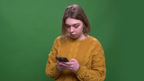 Closeup shoot of young attractive short haired female using the phone looking at Stock Footage 108688076
