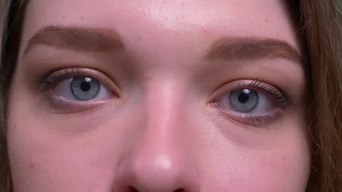 Closeup shoot of young attractive short haired female face looking at camera Video stock 108689175