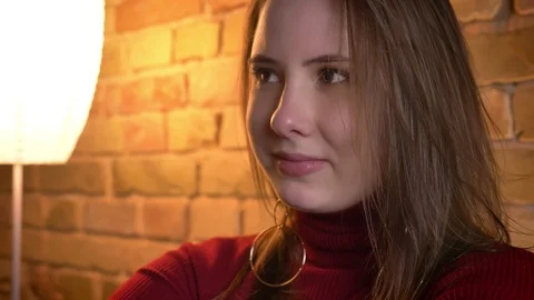 Closeup shoot of young charming plump female turning to camera and smiling in a Stock Footage 103669341