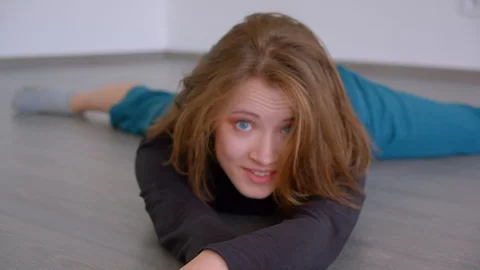 Closeup shoot of young pretty talented female gymnast sitting in twine looking Stock Footage 110279448