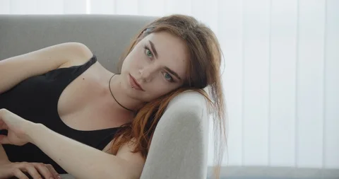 Closeup shoot of young seductive caucasian female in black bodysuit laying on Stock Footage 111960433