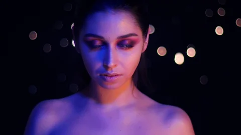 Closeup shoot of young stunning caucasian female with purple neon light and Video stock 106931584