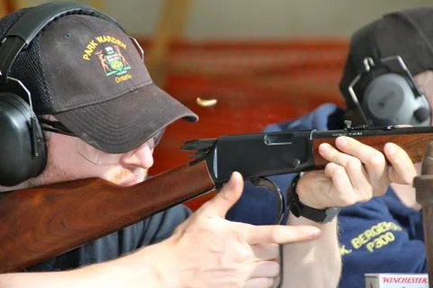 Closeup of shooter ejecting bullet casing Stock Photos