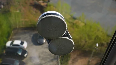 Closeup shooting from above of robot window cleaner washes glass with round rags Stock Footage 241222479