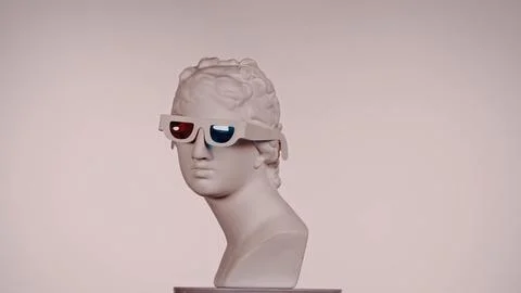 Closeup shot. Ancient marble bust statue of roman era woman in 3d glasses on a Stock Photos