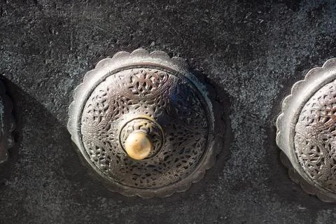 Closeup shot of antique door knobs with carvings 스톡 사진
