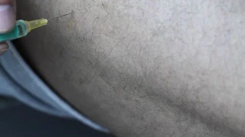 Closeup shot of applying an injection in the thigh with testosterone Stock Footage 220061666