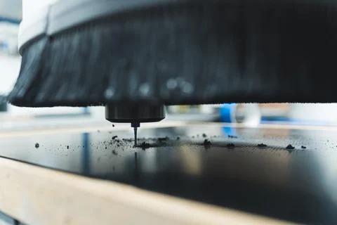 Closeup shot of an automatic milling machine cutting fiber in the factory Stock Photos