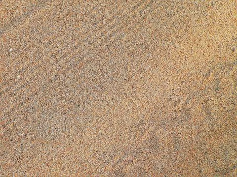 Closeup shot of beach sand texture with different shades of its tiny stones 写真素材