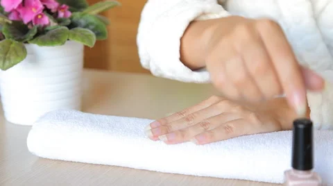 Closeup shot of a beautician applying nail polish to female nail in a nail salon Stock Footage
